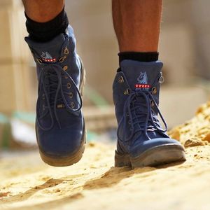 Blue Boots worn by person walking on dirt