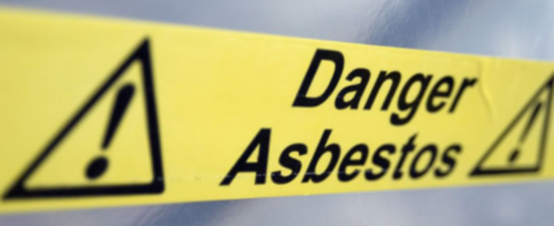 Yellow sign warning of Asbestos Dust
