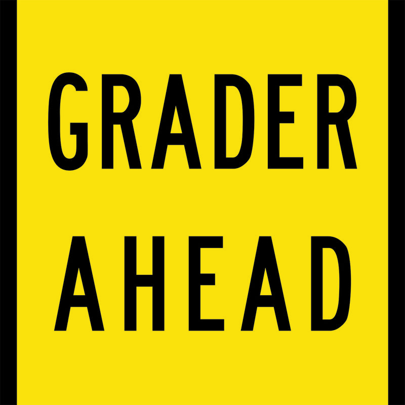 A yellow and black Grader Ahead Sign