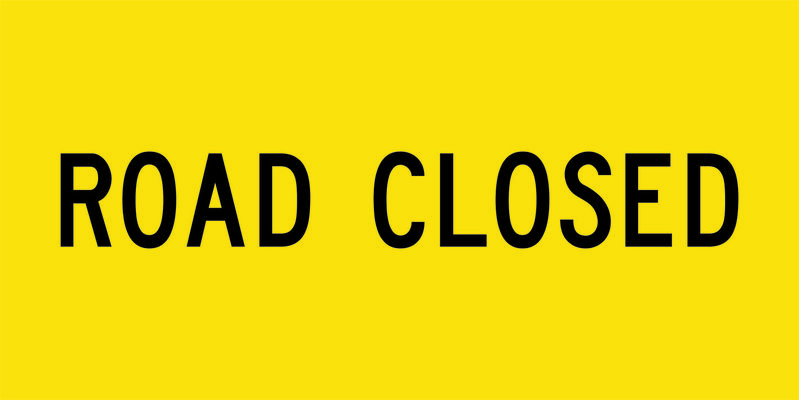 A yellow and black Road Closed Sign