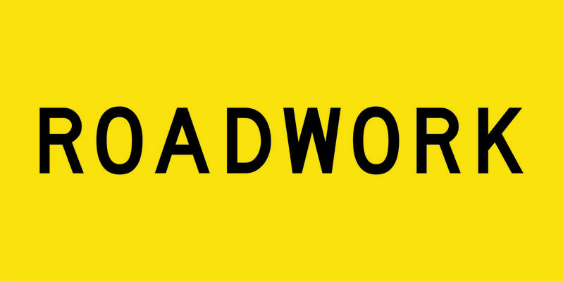 A yellow and black Roadwork Sign